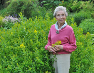Beth Chatto standing in her garden on her 90th birthday